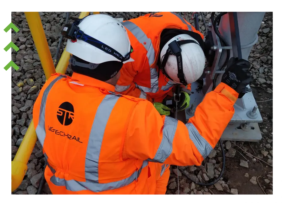 Two SigTech Rail engineers working on trackside signalling equipment